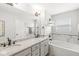 Elegant bathroom featuring double sinks, granite countertops, and a soaking tub at 7254 Cambridge Pl, Avon, IN 46123