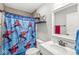 Spacious bathroom with a shower with themed shower curtain, toilet and vanity, offering a comfortable and functional space at 7254 Cambridge Pl, Avon, IN 46123