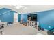 Large bonus room featuring a ceiling fan, blue walls, and ample storage, perfect for versatile use at 7254 Cambridge Pl, Avon, IN 46123