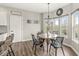 Cozy breakfast nook with round wood table, black chairs, and plenty of natural light from the windows at 7254 Cambridge Pl, Avon, IN 46123