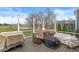 A spacious deck with covered furniture overlooks a green lawn and pond at 7254 Cambridge Pl, Avon, IN 46123