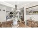 Beautiful dining room with wood table, decorative chandelier, and an open view to the living room and fireplace at 7254 Cambridge Pl, Avon, IN 46123