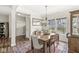 Bright dining room with a chandelier, wooden table, and access to the staircase at 7254 Cambridge Pl, Avon, IN 46123