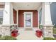 The front porch has a Welcome mat, decorative planters, and stone pillars at 7254 Cambridge Pl, Avon, IN 46123