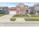 Charming two-story home with a red exterior, a well-kept lawn, and an attached two-car garage at 7254 Cambridge Pl, Avon, IN 46123