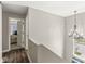 Hallway featuring wood floors and a decorative chandelier with access to a bedroom and a view from a window at 7254 Cambridge Pl, Avon, IN 46123