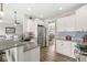 Bright kitchen features granite countertops, stainless steel appliances, and white cabinets with wood floor at 7254 Cambridge Pl, Avon, IN 46123