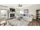 Cozy living room with a fireplace, ceiling fan, and hardwood floors at 7254 Cambridge Pl, Avon, IN 46123