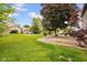 An expansive backyard with mature trees and lush green grass at 7383 Poppyseed Dr, Indianapolis, IN 46237