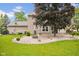 Relaxing backyard with brick patio, fire pit, and lush landscaping for outdoor enjoyment at 7383 Poppyseed Dr, Indianapolis, IN 46237