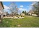 Spacious backyard with a patio, fire pit, shed, basketball court and well-maintained lawn at 7383 Poppyseed Dr, Indianapolis, IN 46237