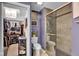 Bathroom with walk-in closet and glass shower, featuring a toilet, storage, and neutral wall coloring at 7383 Poppyseed Dr, Indianapolis, IN 46237