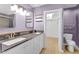 Bathroom featuring a double sink vanity with gray countertops and a walk-in closet at 7383 Poppyseed Dr, Indianapolis, IN 46237