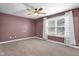 A spacious bedroom with a ceiling fan and a window allowing natural light at 7383 Poppyseed Dr, Indianapolis, IN 46237