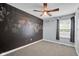 A bedroom with chalkboard wall and ceiling fan at 7383 Poppyseed Dr, Indianapolis, IN 46237