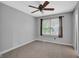Neutral bedroom with carpet, a window with curtains, and a ceiling fan at 7383 Poppyseed Dr, Indianapolis, IN 46237