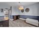 Dining room with gray walls, chair rail, and modern chandelier, with a glimpse into the kitchen at 7383 Poppyseed Dr, Indianapolis, IN 46237