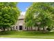 Charming two-story home with a well-manicured lawn and beautiful, mature trees at 7383 Poppyseed Dr, Indianapolis, IN 46237
