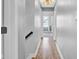 Hallway with wood-look flooring, neutral paint, and access to various rooms, showcasing the home's layout at 7383 Poppyseed Dr, Indianapolis, IN 46237