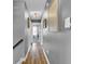 Well-lit hallway with wood flooring and grey walls leading to other rooms at 7383 Poppyseed Dr, Indianapolis, IN 46237