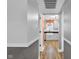 Hallway view into kitchen featuring white cabinets and a farmhouse sink at 7383 Poppyseed Dr, Indianapolis, IN 46237