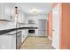 Modern kitchen features white cabinetry, stainless steel appliances, and a black countertop for a sleek design at 7383 Poppyseed Dr, Indianapolis, IN 46237