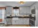 Bright kitchen featuring white cabinets, stainless steel appliances, and a farmhouse sink at 7383 Poppyseed Dr, Indianapolis, IN 46237