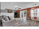 Spacious living room with modern flooring, a gray sofa, and a sliding glass door at 7383 Poppyseed Dr, Indianapolis, IN 46237