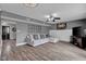 Comfortable living room with gray walls, wood flooring, a sectional sofa, and a television at 7383 Poppyseed Dr, Indianapolis, IN 46237