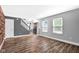 Spacious living room with staircase, natural light, and attractive wood-look flooring at 7383 Poppyseed Dr, Indianapolis, IN 46237
