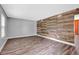 Bright living room with hardwood floors, wood accent wall, and neutral color scheme at 7383 Poppyseed Dr, Indianapolis, IN 46237