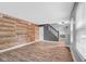 Spacious living room featuring wood accent wall, lots of light, and modern flooring at 7383 Poppyseed Dr, Indianapolis, IN 46237