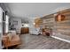 Inviting living room with modern flooring, stylish decor, wood accent wall, and ample natural light at 7383 Poppyseed Dr, Indianapolis, IN 46237