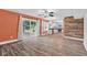 Open-concept living area with plank flooring, leading to kitchen and patio through sliding glass doors at 7383 Poppyseed Dr, Indianapolis, IN 46237