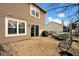 Paver patio with sliding glass door and outdoor furniture, including a grill and covered table at 7383 Poppyseed Dr, Indianapolis, IN 46237