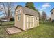 A backyard storage shed is painted with white trim, has double doors and a solid foundation at 7383 Poppyseed Dr, Indianapolis, IN 46237