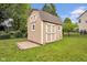 Tan backyard shed features a concrete pad to help keep the yard tidy at 7383 Poppyseed Dr, Indianapolis, IN 46237