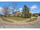 Neighborhood street view showcasing a well-kept lawn with landscaping, and nearby homes in a residential area at 7383 Poppyseed Dr, Indianapolis, IN 46237