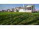 Large, lush backyard with manicured lawn and a partial view of the home's exterior at 7713 Imperial Eagle Dr, Zionsville, IN 46077