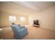 Basement living area featuring cozy armchairs, carpeted floors, and a television at 7713 Imperial Eagle Dr, Zionsville, IN 46077