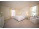 Bright bedroom featuring carpet, large windows with yellow curtains, a white quilt bed, and white furniture at 7713 Imperial Eagle Dr, Zionsville, IN 46077