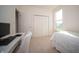 Sunlit bedroom featuring a bed, desk, chair, a closet, and a large window at 7713 Imperial Eagle Dr, Zionsville, IN 46077