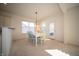 Sunny dining area with large window, with stylish, brightly painted chairs around a white wooden table at 7713 Imperial Eagle Dr, Zionsville, IN 46077