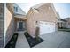 Inviting front entrance with a gray door, complemented by beautiful landscaping and an attached two car garage at 7713 Imperial Eagle Dr, Zionsville, IN 46077