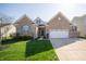 Charming brick home with a well-manicured lawn and attached two car garage, complemented by blue shutters at 7713 Imperial Eagle Dr, Zionsville, IN 46077