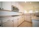 Well-equipped kitchen with light cabinets, stainless steel microwave and a cooktop, with durable countertops at 7713 Imperial Eagle Dr, Zionsville, IN 46077