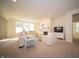 Bright living room featuring neutral colors, carpet floors, a cozy fireplace, and large windows for ample natural light at 7713 Imperial Eagle Dr, Zionsville, IN 46077