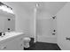 Clean bathroom featuring a tub, shower, tiled floors, and white cabinets at 7845 Bluff Rd, Indianapolis, IN 46217