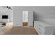 Bedroom showing carpeted floor, white walls and a peek into the bathroom at 7845 Bluff Rd, Indianapolis, IN 46217