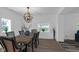 Dining room with wood table, chairs and modern light fixture at 7845 Bluff Rd, Indianapolis, IN 46217